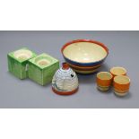 A Clarice Cliff Pine Grove honey jar, an abstract bowl, three egg cups and a pair of cube