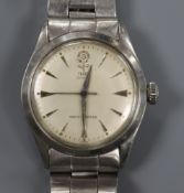 A gentleman's stainless steel Tudor Oyster manual wind wrist watch, on a stainless steel Rolex