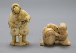 Two early 20th century Japanese ivory netsuke of a peasant woman with swivelling face and a doll