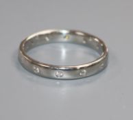 A modern platinum and gypsy set diamond eternity ring, size N.