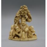 A Meiji period ivory okimono netsuke of rakan beneath a tree