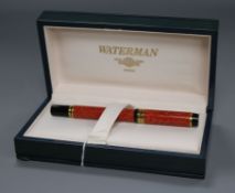 A Waterman 'Ideal' fountain pen, in marbled red, black and gilt, in lacquered box