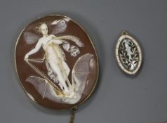 An early 20th century yellow metal cameo brooch depicting a fairy on a bat in flight and a yellow