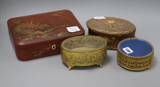 A Japanese red lacquered box, an oval gilt composition box and cover and two gilt boxes largest 18.5