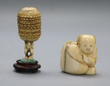 A late 19th century Japanese walrus ivory netsuke of a boy and sack and an ivory netsuke of a man