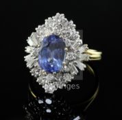 A modern 18ct gold, sapphire and diamond cluster ring, of quatrefoil shape, the oval cut sapphire