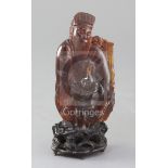 A Chinese amber group of a sage and a boy, Qing dynasty, standing before a prunus tree, attached