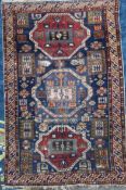A Shirvan blue ground rug, with three central polygons in a field of geometric hooked motifs, with