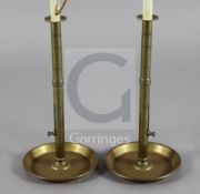 A pair of tall brass 'pulpit' chambersticks, c.1820, each with side eject buttons, fitted for