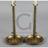 A pair of tall brass 'pulpit' chambersticks, c.1820, each with side eject buttons, fitted for