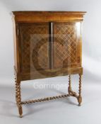 A William and Mary walnut cabinet on stand, with cushion drawer and two doors enclosing a cupboard
