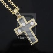 A Chopard 'Happy Diamond' glass-panelled cross pendant, containing three floating collet-set