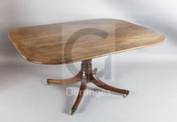 A Regency mahogany breakfast table, with satinwood banded rounded rectangular tilt top, on reeded