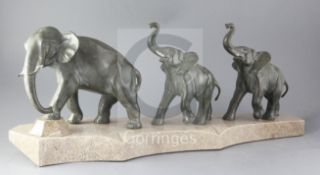 Brault. An Art Deco bronze group of elephants, a mother and two calves, mounted on a shaped marble