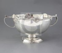 A late Victorian silver two handled punch bowl, by Martin, Hall & Co, with panelled body and pierced