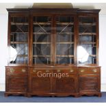 An Edwardian George III style mahogany breakfront library bookcase, with dentil cornice, blind