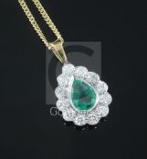 An 18ct white and yellow gold, emerald and diamond tear drop pendant, claw and millegrain-set, on