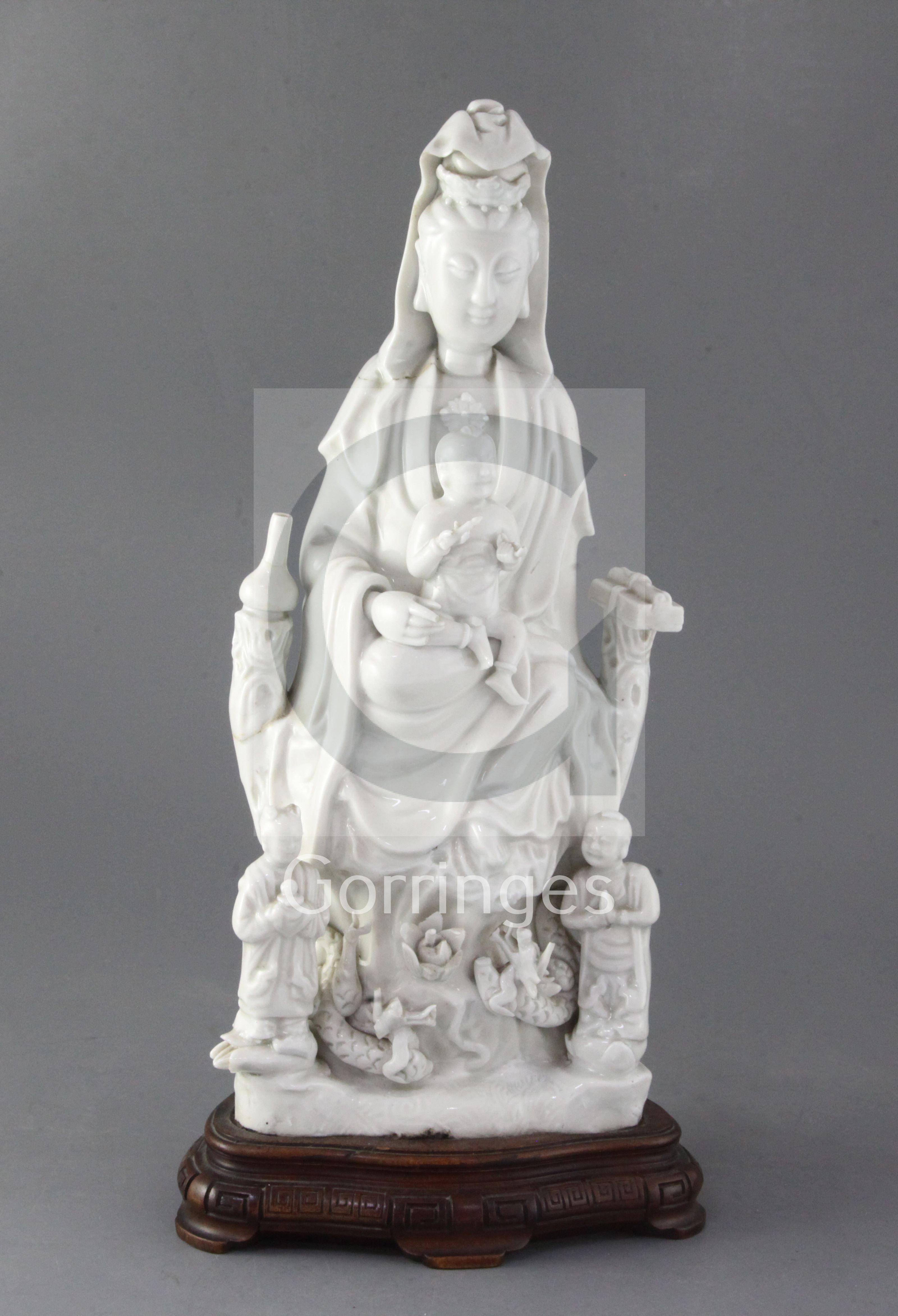 A Chinese Dehua blanc de chine group of Guanyin with child and attendants, 17th/18th century 36cm,