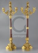 A pair of second quarter of the 19th century French ormolu and rouge marble four light candelabra,