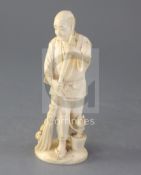 A Japanese ivory okimono of a man and a puppy, early 20th century, the man holding a brush, engraved