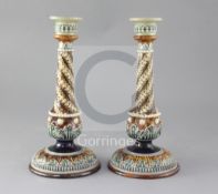 A pair of Doulton Lambeth stoneware candlesticks, with applied spiral fluted decoration, height