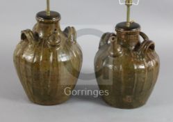 Two similar 17th century French, Auvergne, terracotta spouted jars, with triple strap handles and