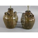 Two similar 17th century French, Auvergne, terracotta spouted jars, with triple strap handles and