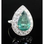 An 18ct white gold, emerald and diamond pear shaped dress ring, the pear shaped emerald measuring