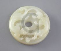 A Chinese pale celadon jade bi disc, 19th century the stone with occasional very pale russet