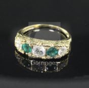 A modern Victorian style 18ct gold, emerald and diamond five stone half hoop ring, with carved