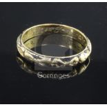 A George II yellow metal and black enamelled 'double' mourning ring, decorated with two skeletons,