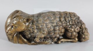 A 16th century Flemish oak deep relief figure of the recumbent lamb W.29in.