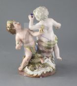 A Meissen group of two putti emblematic of Europe and America, with the figure of a crocodile