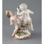 A Meissen group of two putti emblematic of Europe and America, with the figure of a crocodile