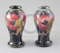 Two Moorcroft miniature pomegranate pattern baluster vases, green W Moorcroft signatures and