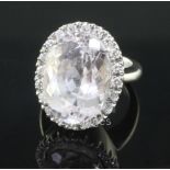 An 18ct white gold, kunzite and diamond oval cluster dress ring, size L.