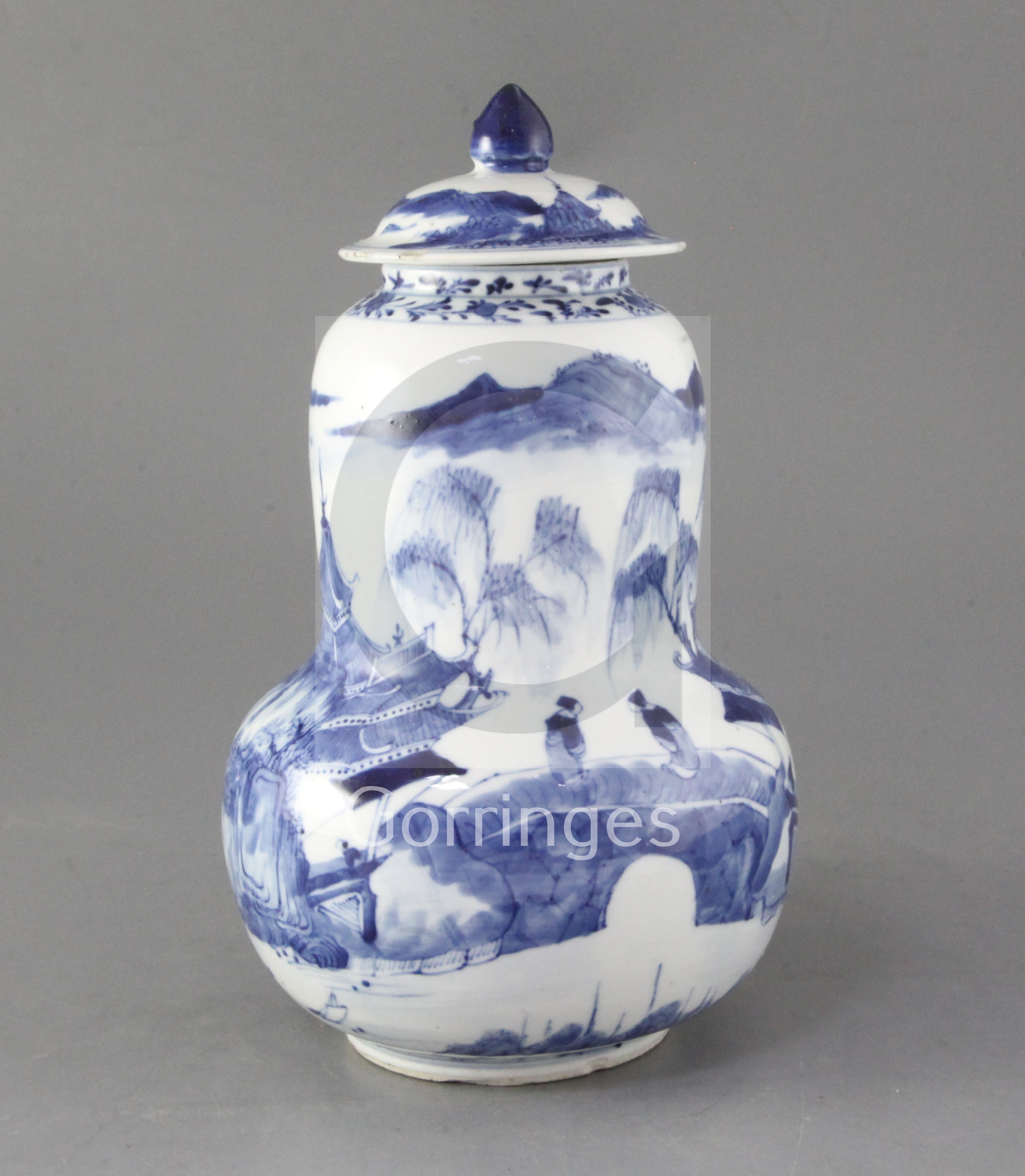 A Chinese blue and white gourd-shaped vase and cover, late 19th century, painted with figures amid