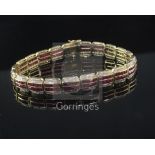 A modern 18ct yellow gold, ruby and diamond line bracelet, with two rows of channel set rubies