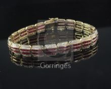 A modern 18ct yellow gold, ruby and diamond line bracelet, with two rows of channel set rubies