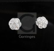 A pair of platinum and diamond seven-stone cluster ear studs, 12mm.