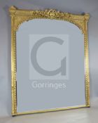 A ornate Victorian giltwood and gesso wall mirror, with arched plate, W.5ft 10in. H.6ft 11in.