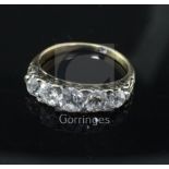A late Victorian 18ct gold and graduated five stone old mine cut diamond ring, size Q.