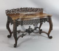 A 19th century Anglo-Indian padouk wood side table, carved and pierced throughout with vineous