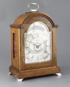 A silver mounted mahogany quarter chiming table clock, by J.W. Elliott Ltd for Garrard, the break