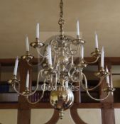 A late 19th century Dutch brass twelve light chandelier, with ball and baluster stem supporting