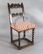 A late 17th century French oak rail back chair, with eagle head cresting and scroll mid bar, over-