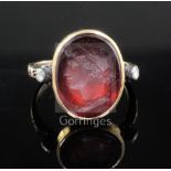 A Georgian yellow metal and oval red intaglio foil backed? ring with old cut diamond set