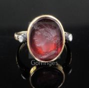 A Georgian yellow metal and oval red intaglio foil backed? ring with old cut diamond set