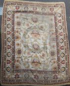 An Indian carpet of Ziegler style, the ivory field with bold flowerheads, palmettes and vine and