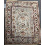 An Indian carpet of Ziegler style, the ivory field with bold flowerheads, palmettes and vine and